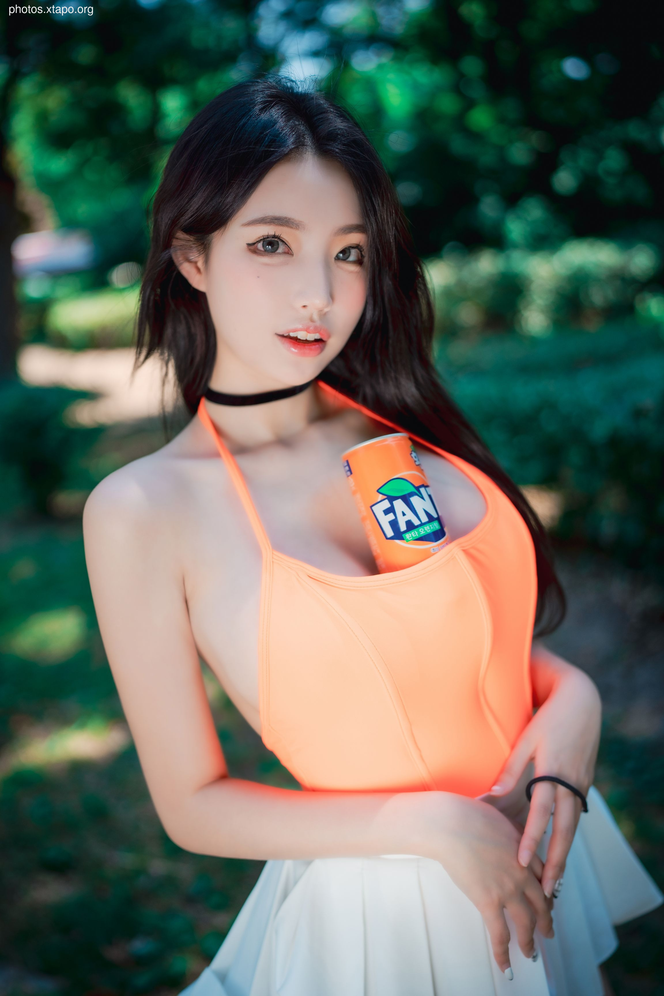 A young woman enjoys a cool drink on a warm summer day.