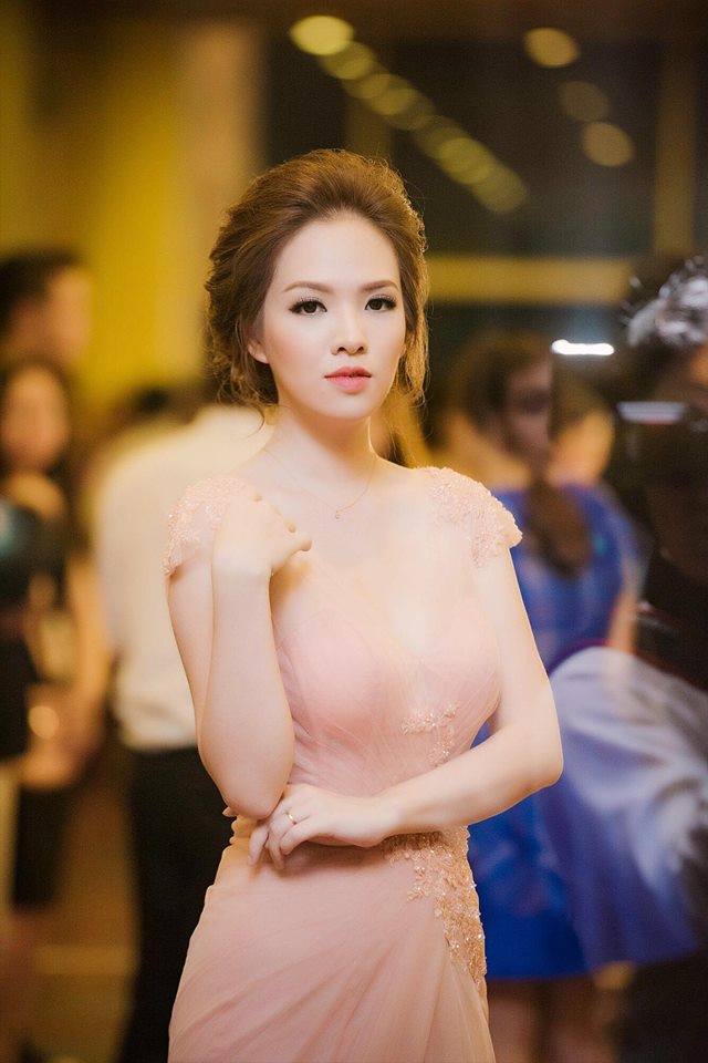 A woman in a beautiful blush-colored gown at an evening event.