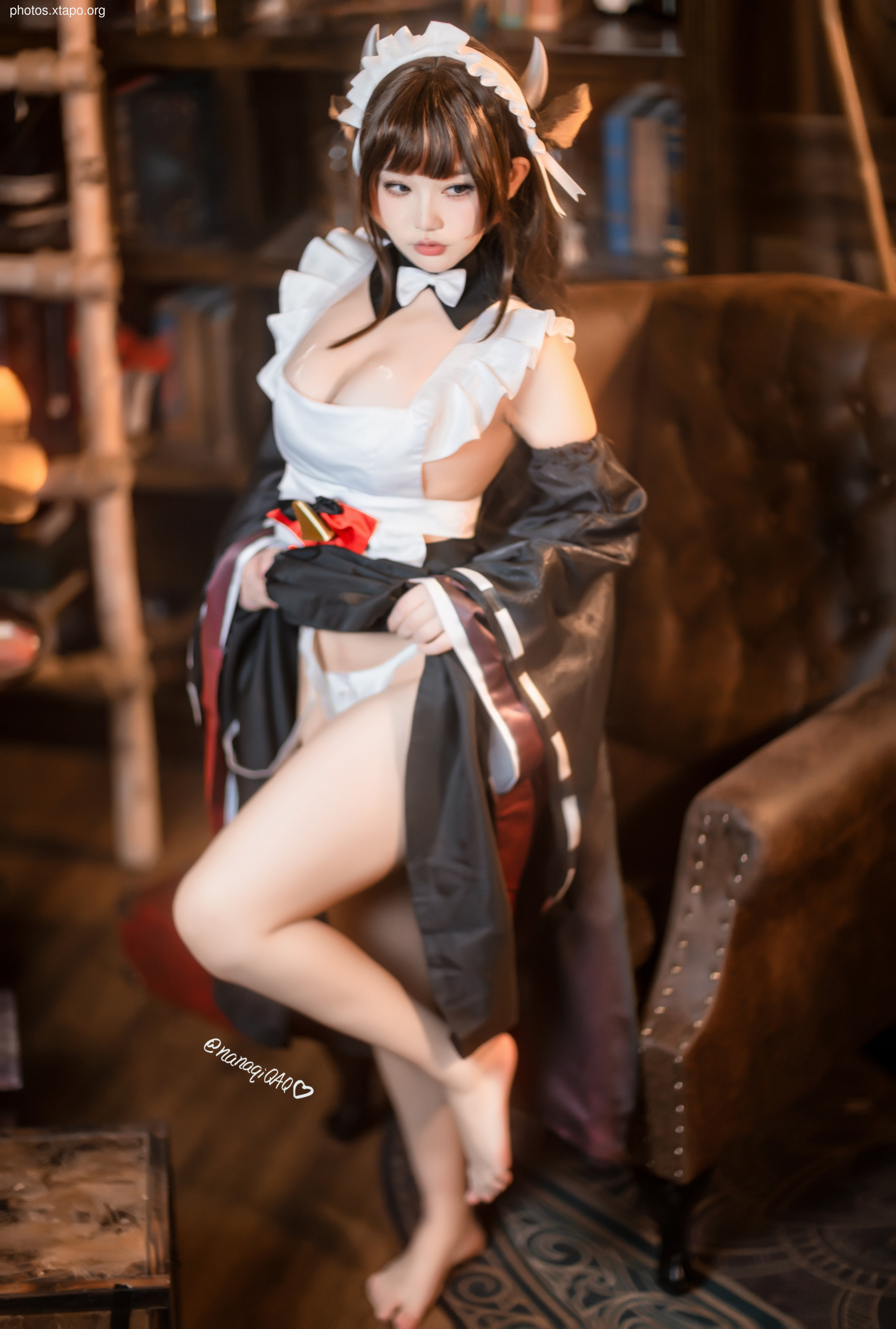 A captivating cosplay photograph of a young woman dressed as a maid with devil horns, showcasing a blend of cute and edgy aesthetics. The image is set against a backdrop of a dimly lit, antique-styled interior, enhancing the overall mood and theme.