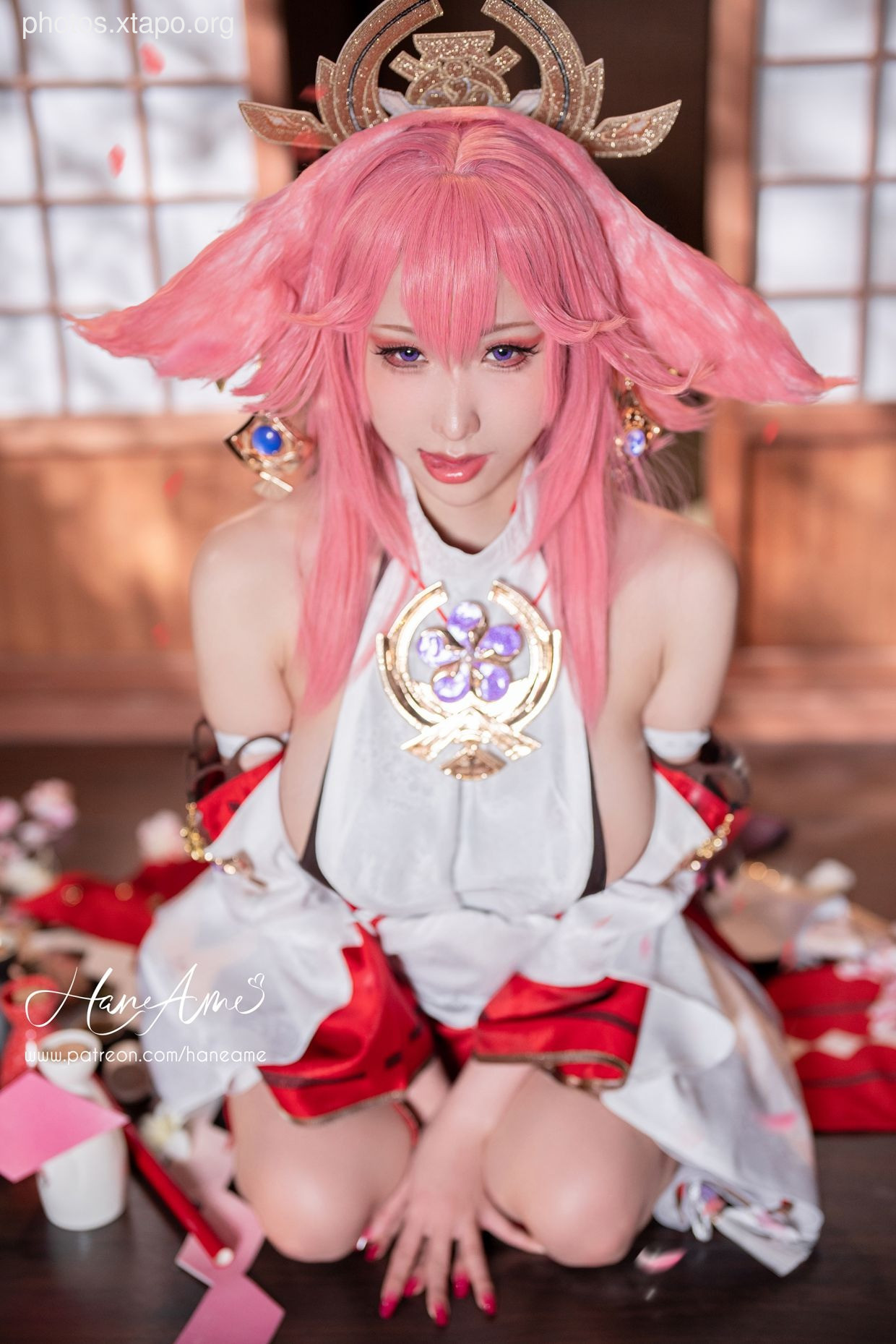 A stunning cosplay of a Genshin Impact character, showcasing intricate details of the costume and makeup. The model's pose and expression perfectly capture the essence of the character.