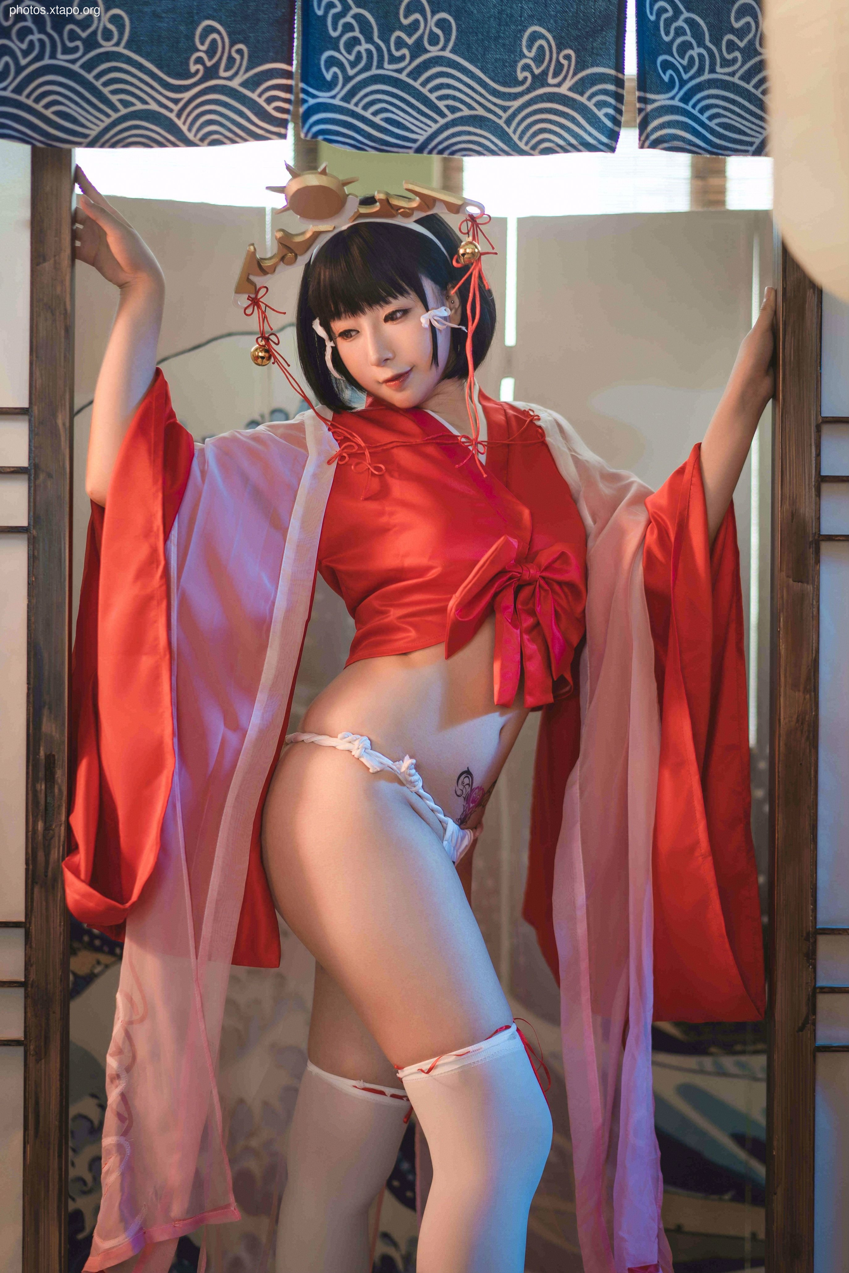 A captivating model poses in a traditional red and white kimono, showcasing intricate details and elegant accessories. The image is set against a backdrop of traditional Japanese screens.