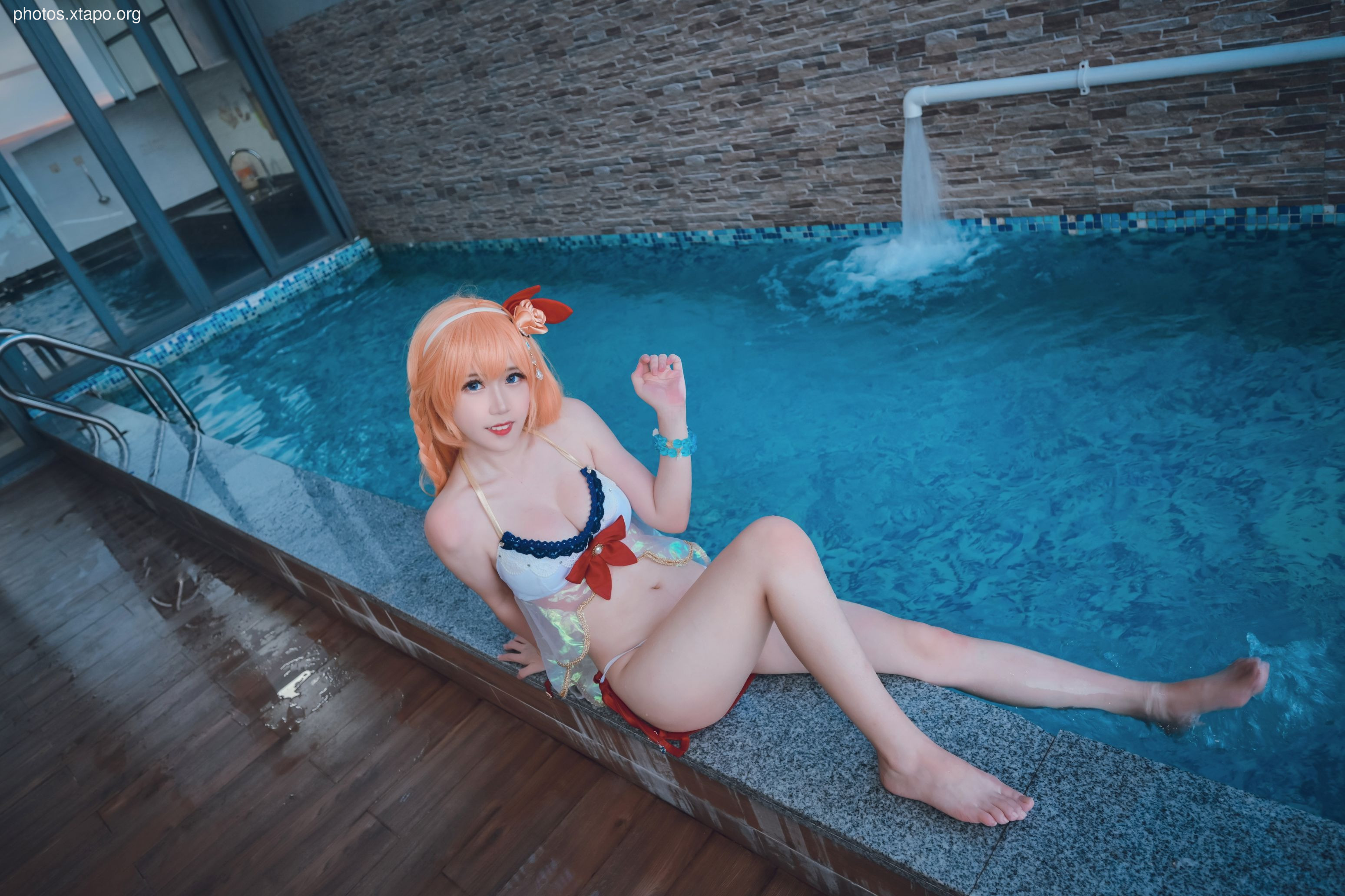 A cosplayer, dressed in a cute swimsuit, poses by a pool. The image is vibrant and well-lit, showcasing the cosplayer's costume and the pool setting.