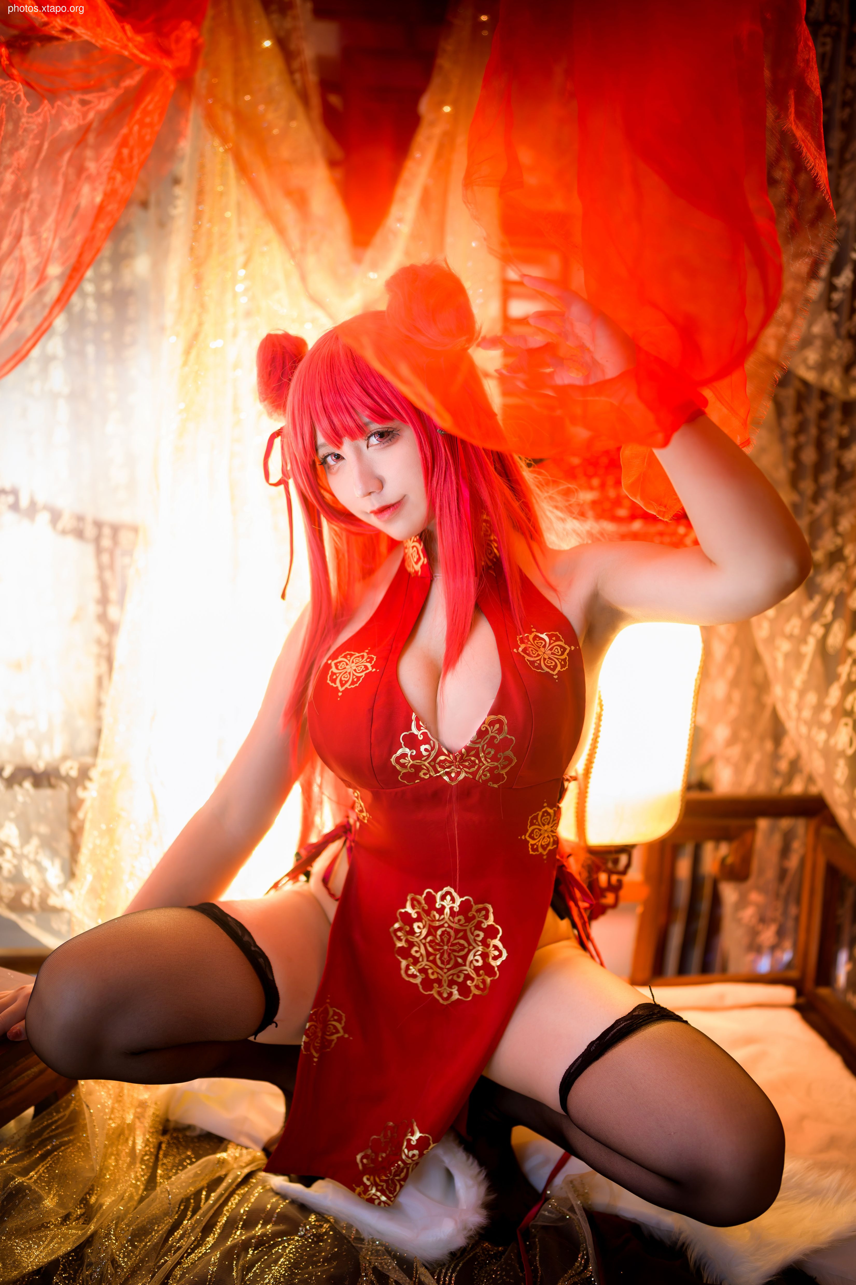 A captivating cosplay photoshoot featuring a model in a vibrant red cheongsam, adorned with gold embroidery. The image showcases the intricate details of the costume against a warm, ambient backdrop.