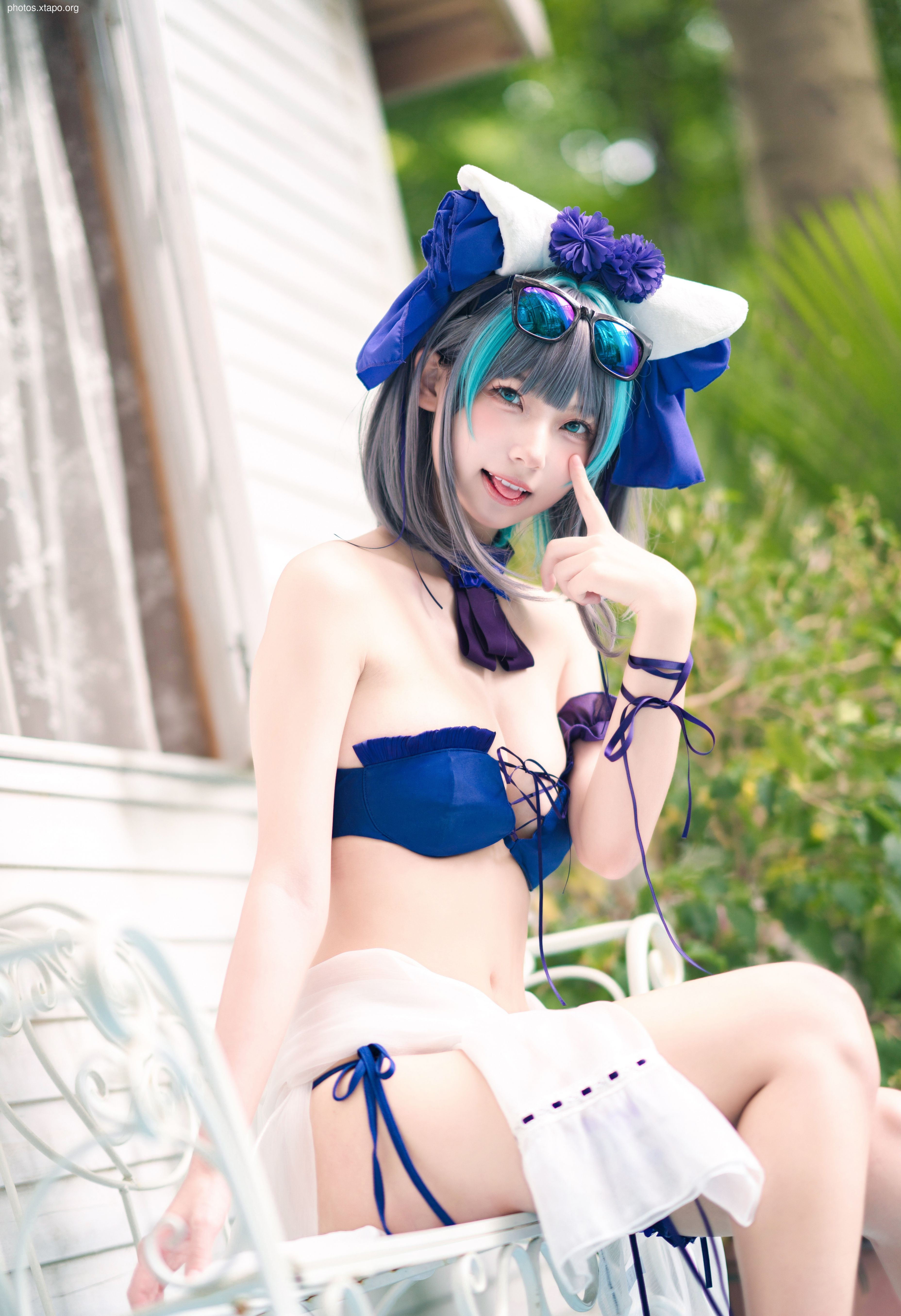 A captivating cosplay of a character in a summery blue and white bikini.  The model's vibrant teal hair and stylish hat add to the overall aesthetic.
