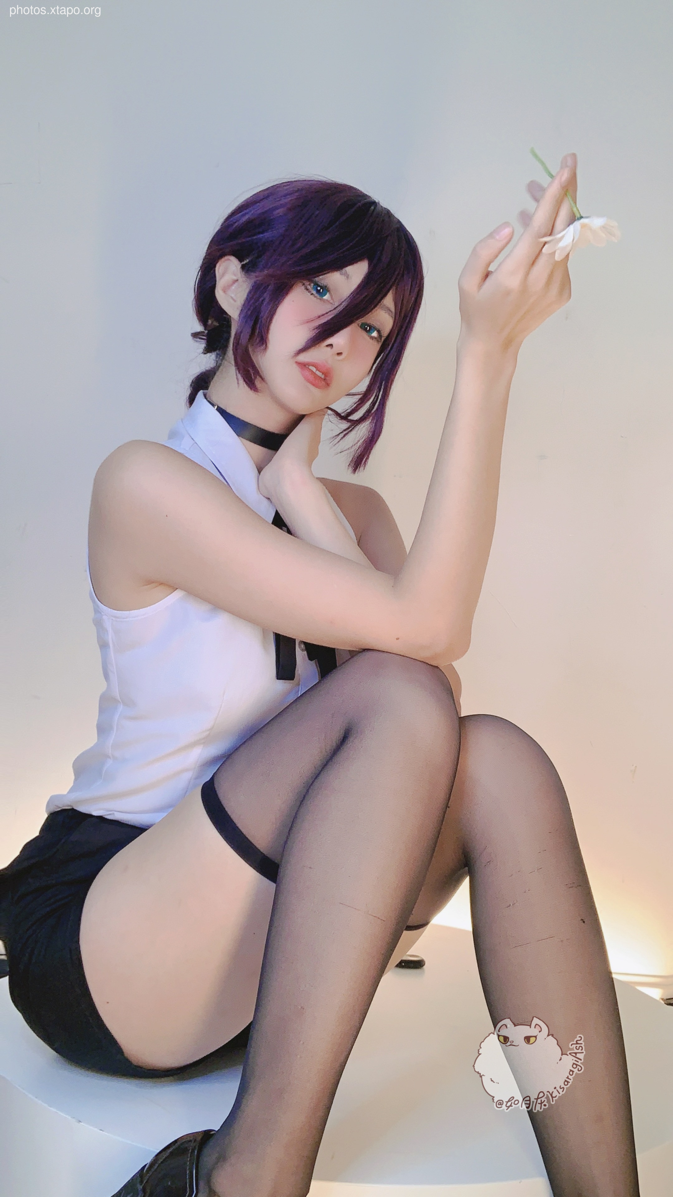 A captivating cosplay of a character with purple hair, wearing a white sleeveless top and black stockings. The model holds a flower, adding a touch of elegance to the scene.