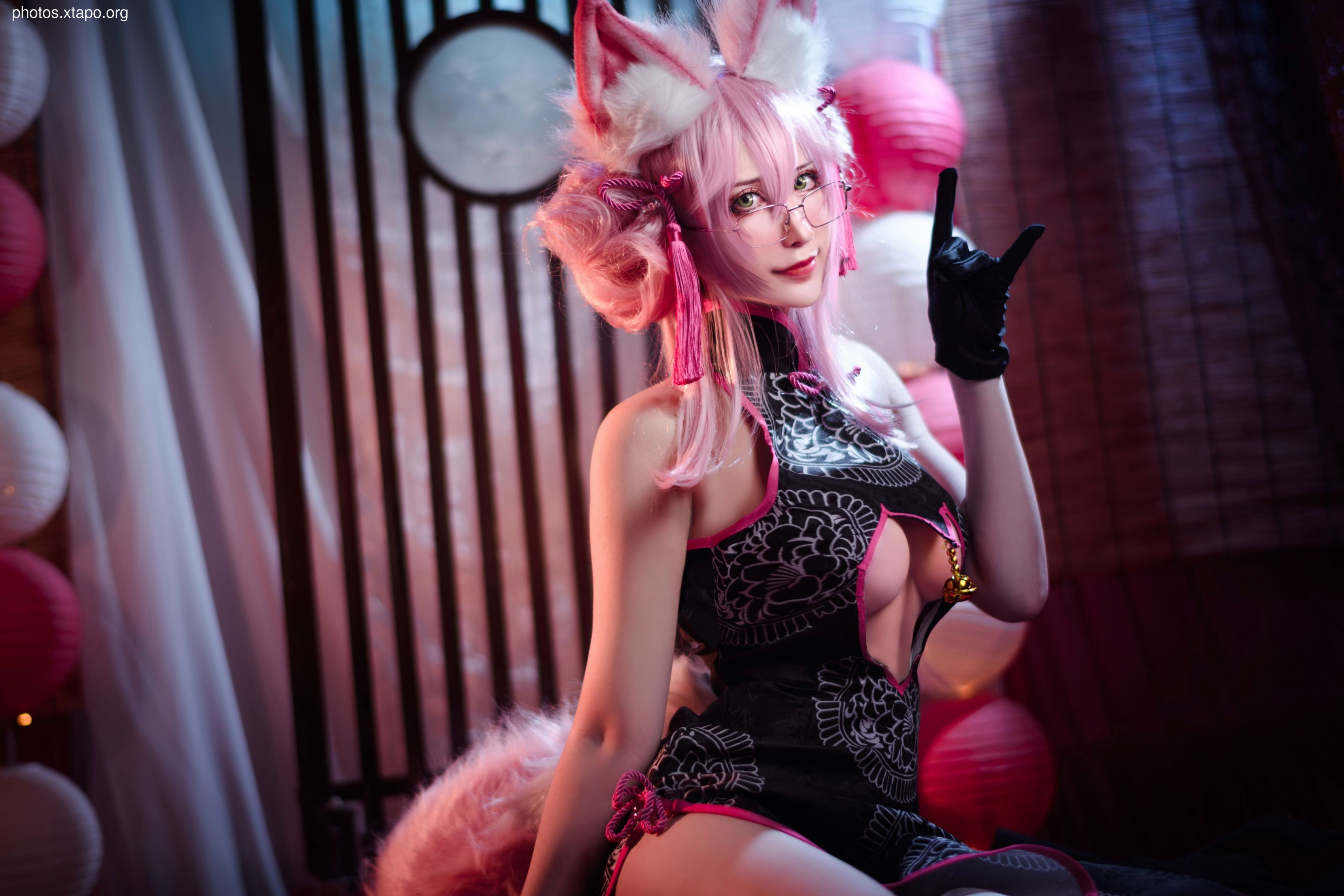A captivating cosplay photoshoot featuring a model in a cheongsam dress with fox ears and pink hair. The image showcases a blend of traditional Chinese attire and anime aesthetics.