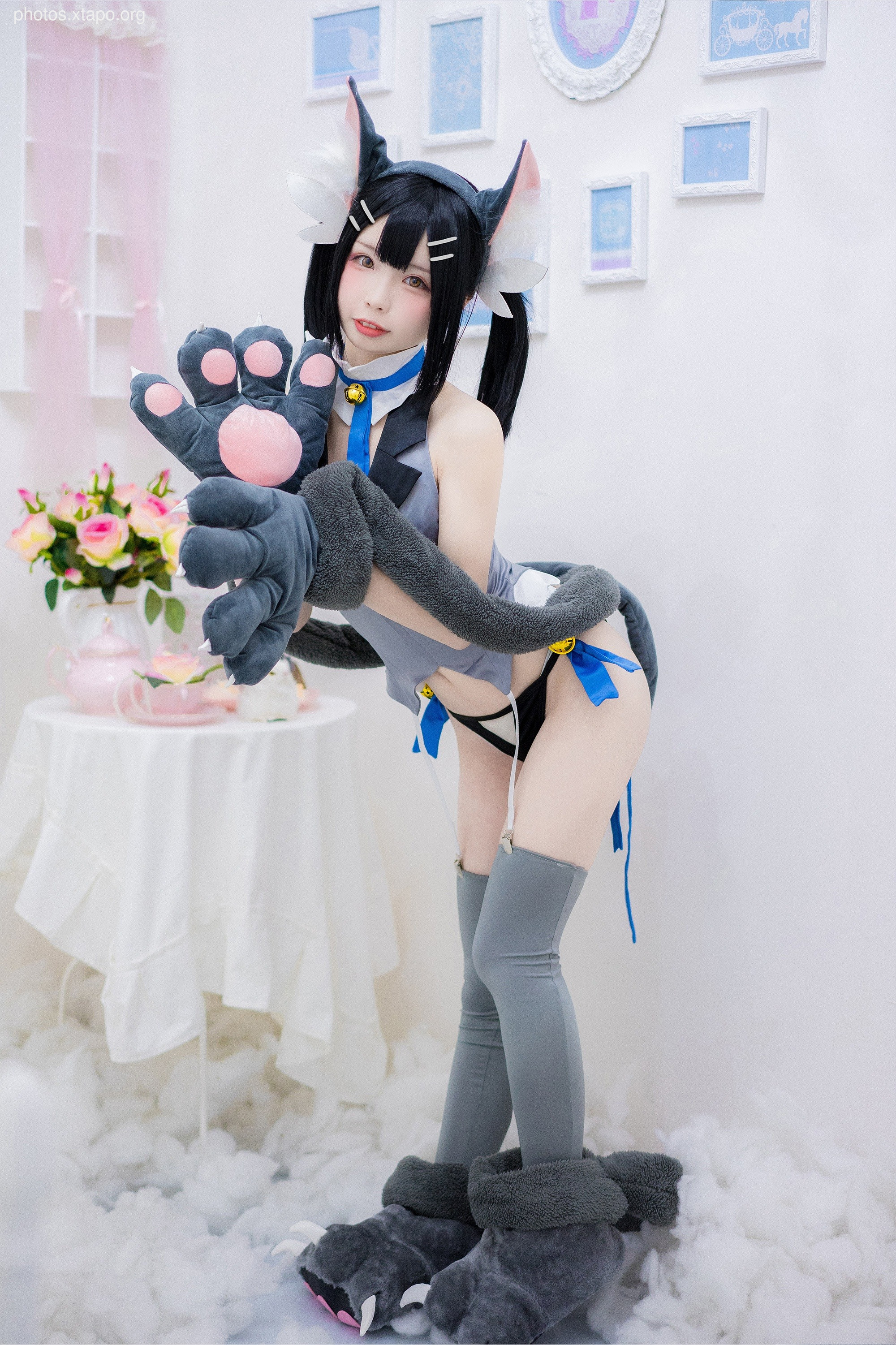 A captivating cosplay of a cat girl, showcasing intricate details and a playful pose. The model's expression and attire perfectly embody the character, creating a visually stunning image.