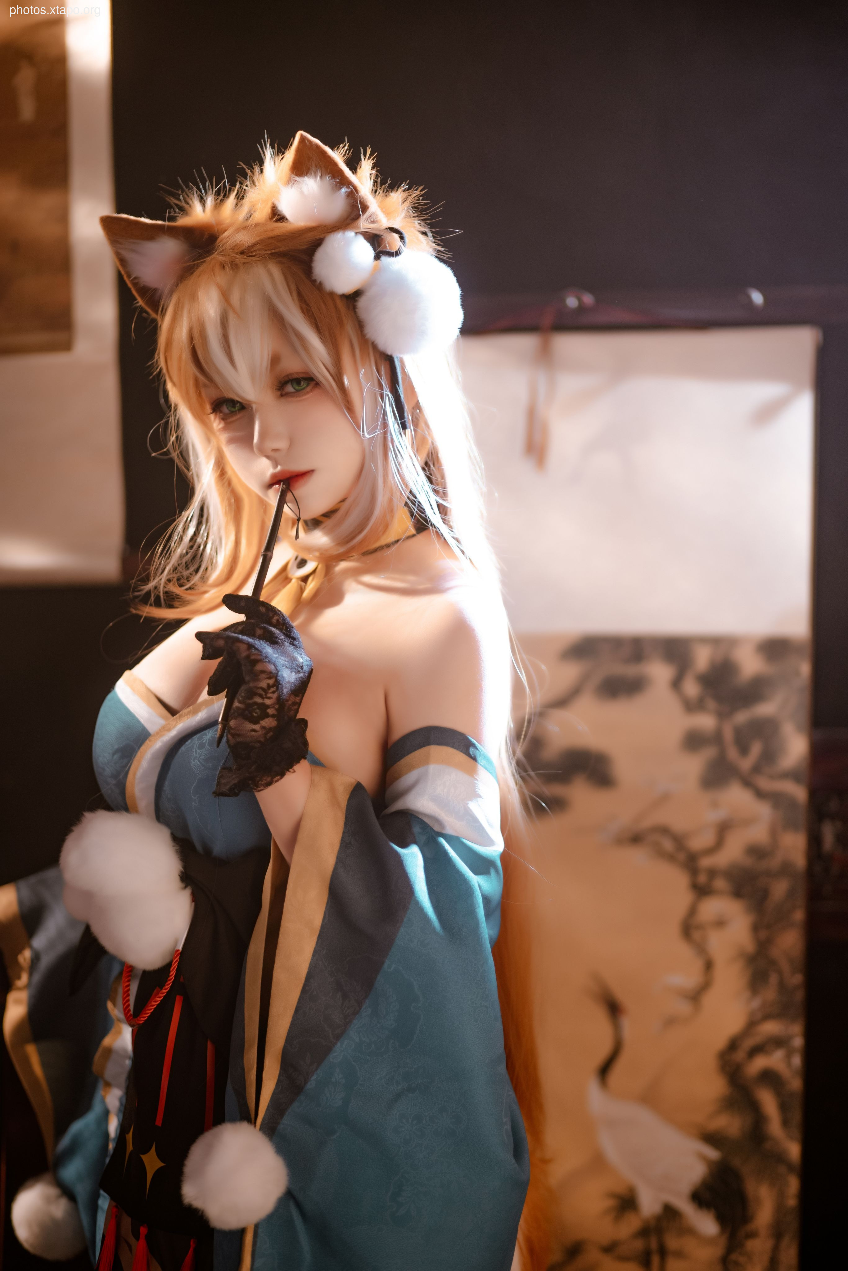 A captivating cosplay of a kitsune goddess, adorned in a teal and gold kimono, fox ears, and intricate details.  The model's expression and pose add to the mystical atmosphere.