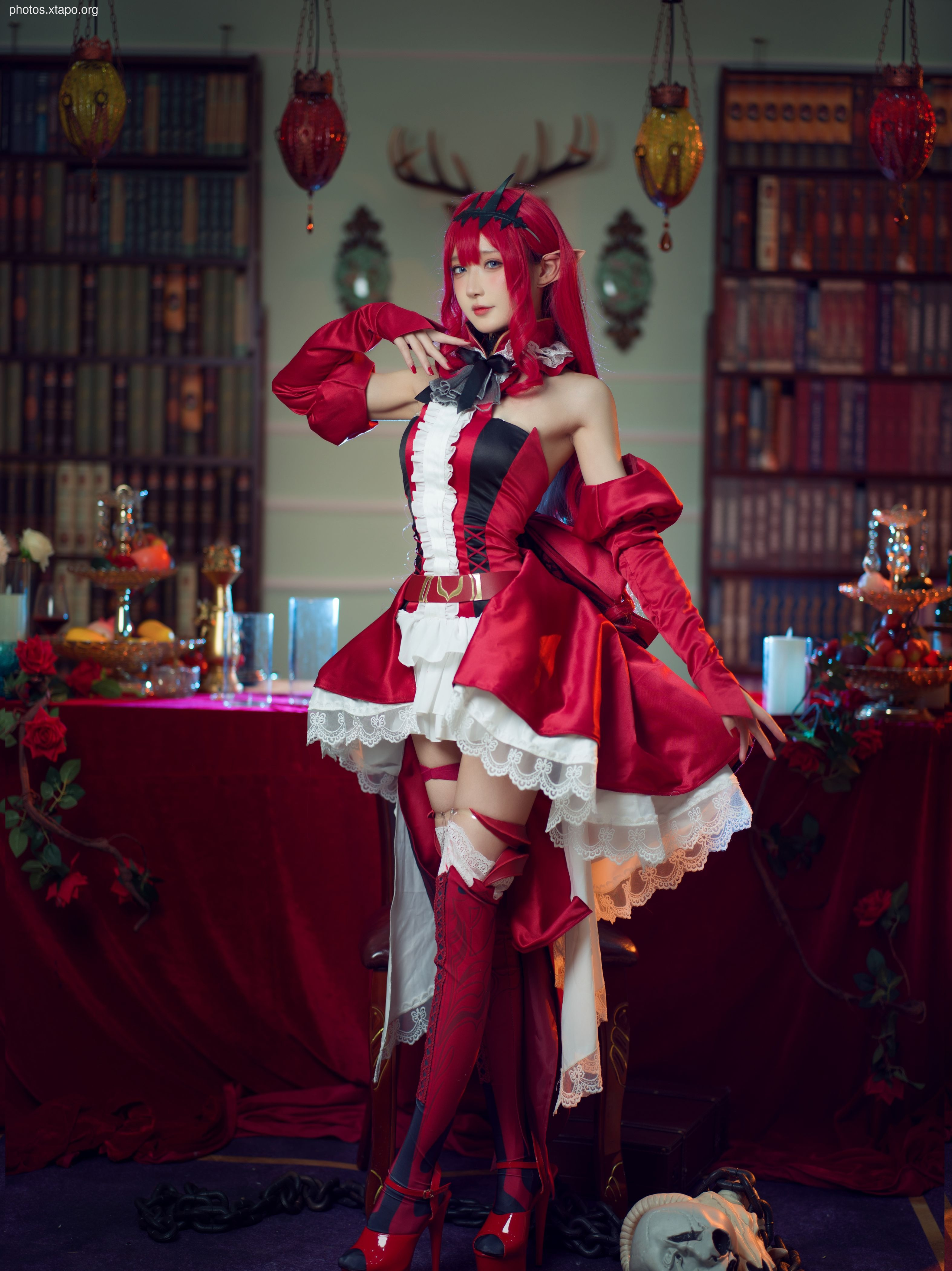 A stunning cosplay of an enchanting character in a crimson dress, posing in a dramatic setting. The details of the costume are exquisite, and the model's pose is captivating.