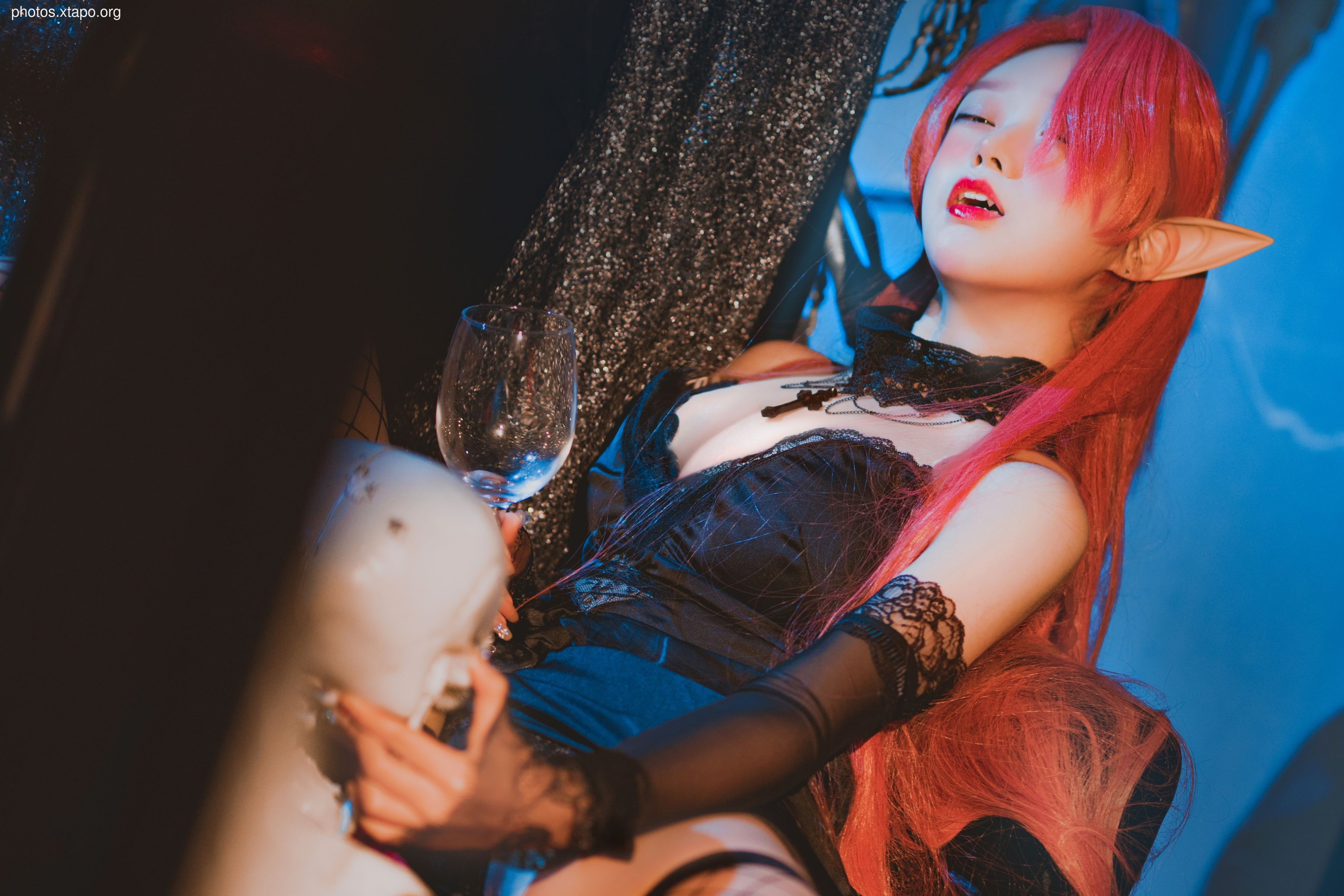 A captivating portrait of an elf in gothic attire, holding a glass and gazing intently.  The image features rich, dark tones and a dramatic lighting style.