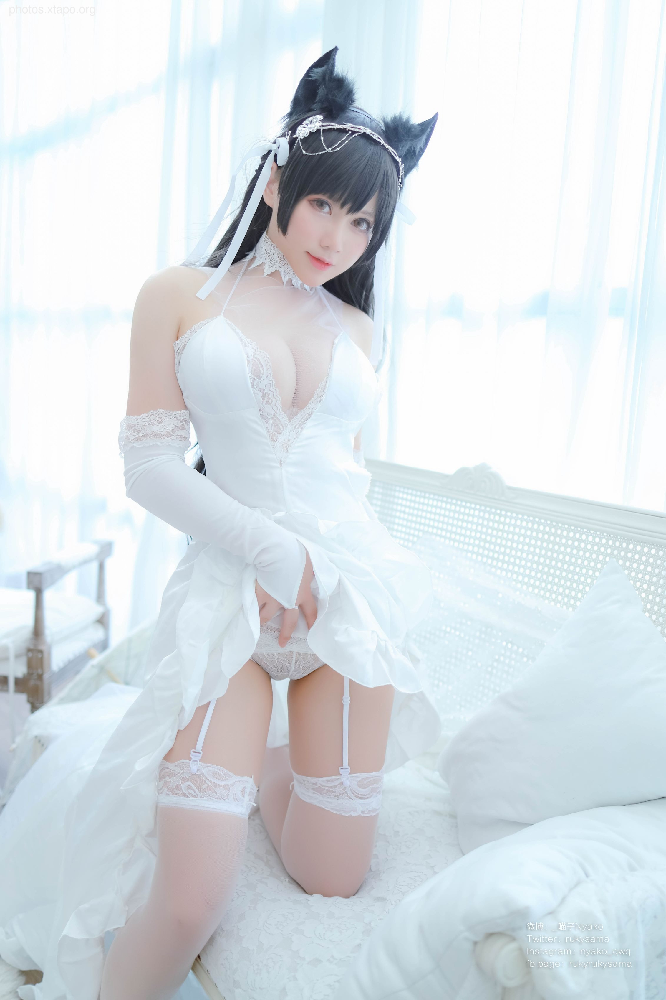 A captivating cosplay of a bride in a stunning white dress and cat ears.