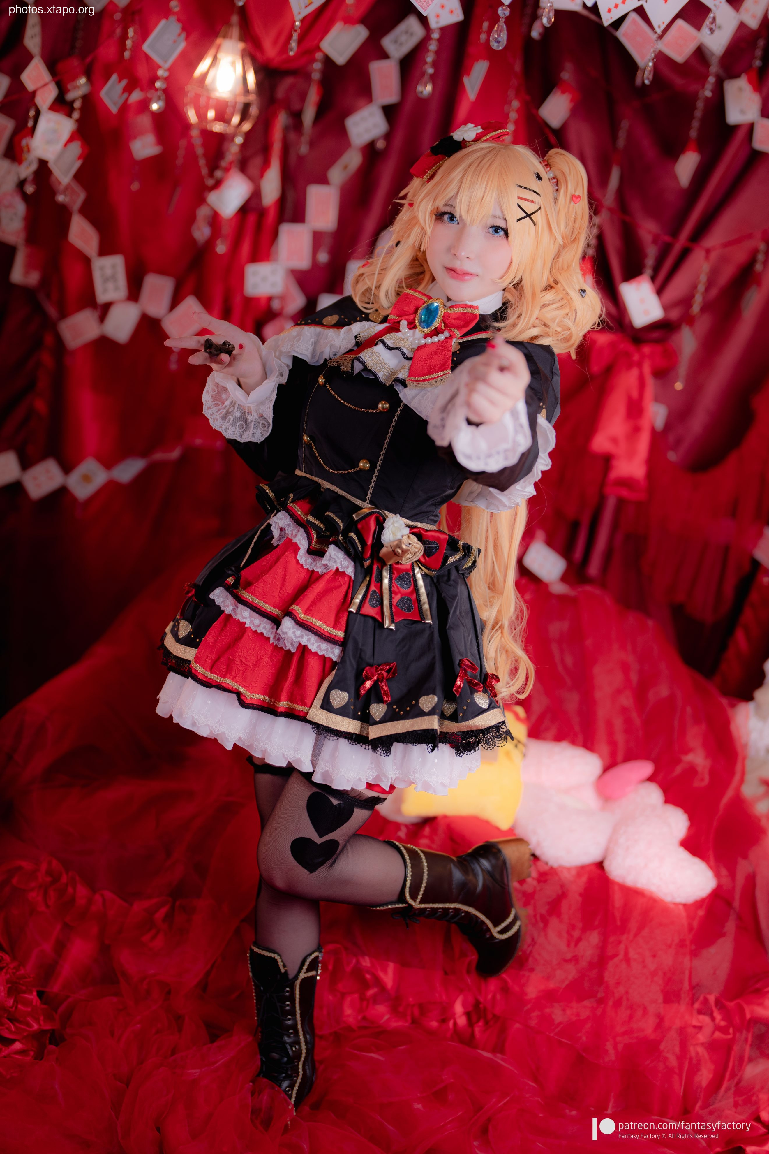 A stunning cosplay of the Queen of Hearts, complete with a regal red and black dress, intricate details, and dramatic posing.  The setting perfectly complements the character, creating a captivating image.